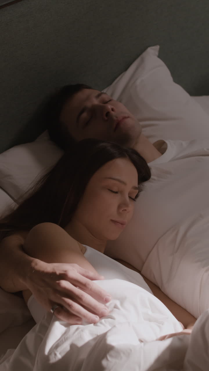 Couple Sleeping in Bed