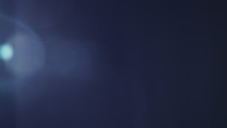 soft blue lens flare with a gentle light gradient across a clear black background. ideal for overlays, transitions, visual effects, or adding atmosphere to creative projects