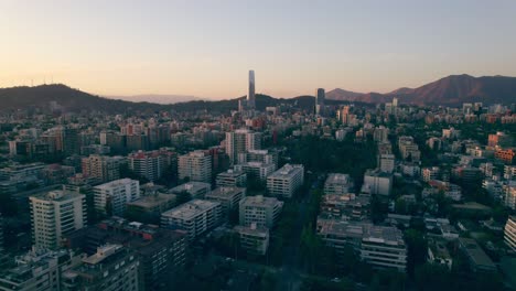 neighborhood in providencia with costanera center complex in the distance in santiago, chile