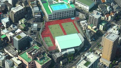 aerial view of people playing on the soccer field from from skytree tower