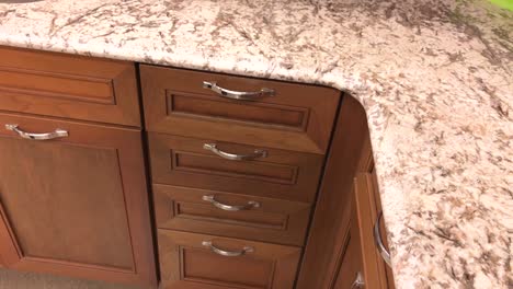 traditional wooden kitchen cabinets with slow motion closing of the kitchen drawer, hand of person visible