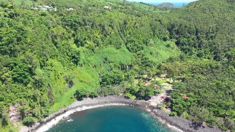 closing in on multiple jungle waterfalls on a green tropical island aerial