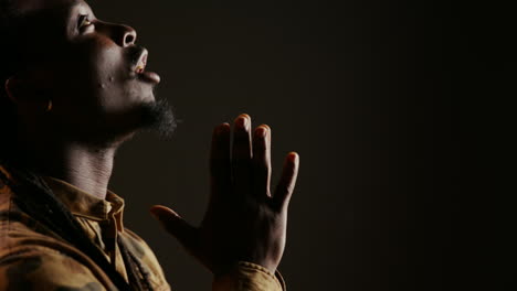 religious adult believing in jesus and praying in studio