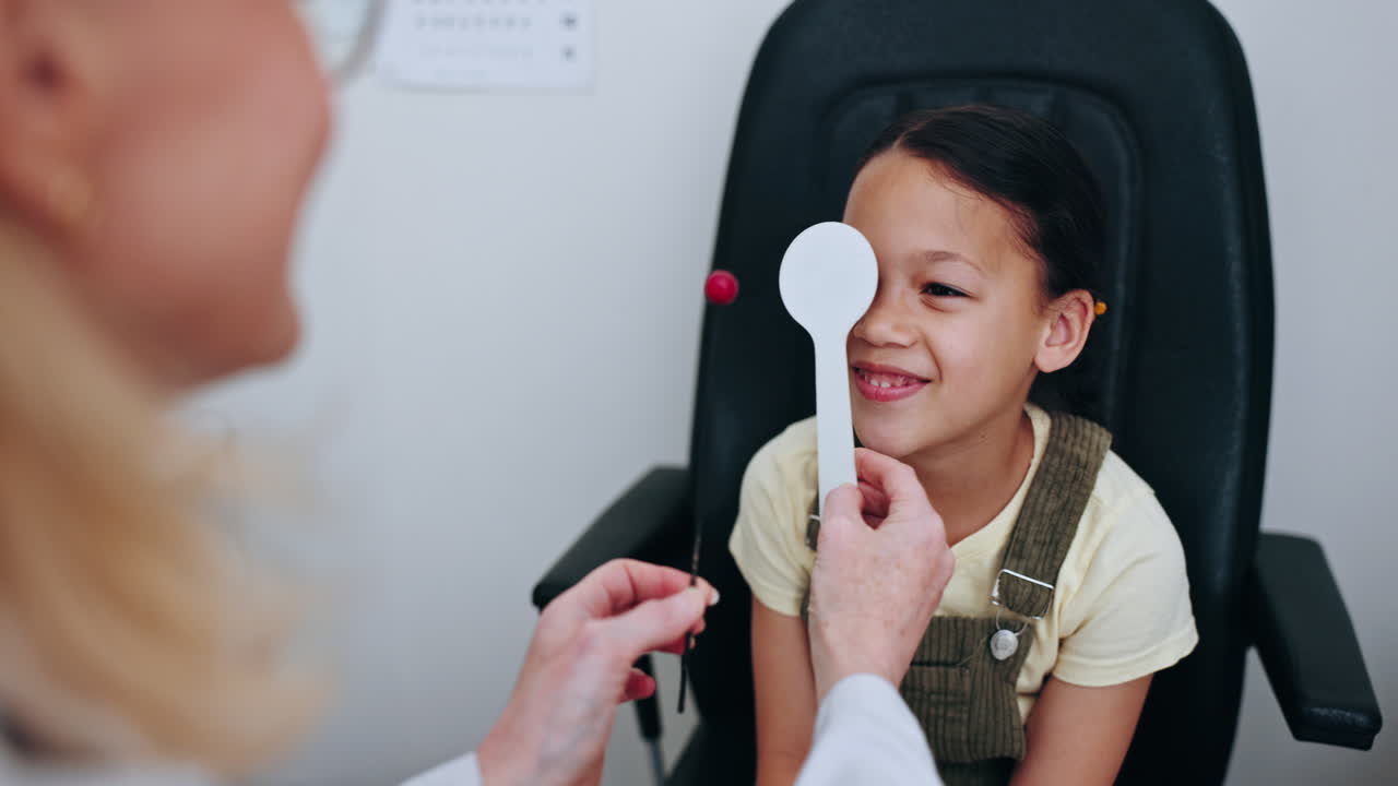 Eye exam, patient and optometrist cover child