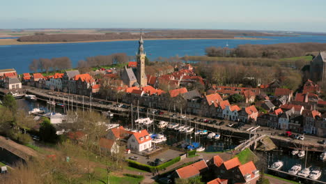 Aerial:-The-historical-town-of-Veere-with-an-old-harbour-and-churches,-on-a-spring-day