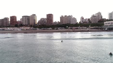 surfing in the city of mar del plata during sunrise