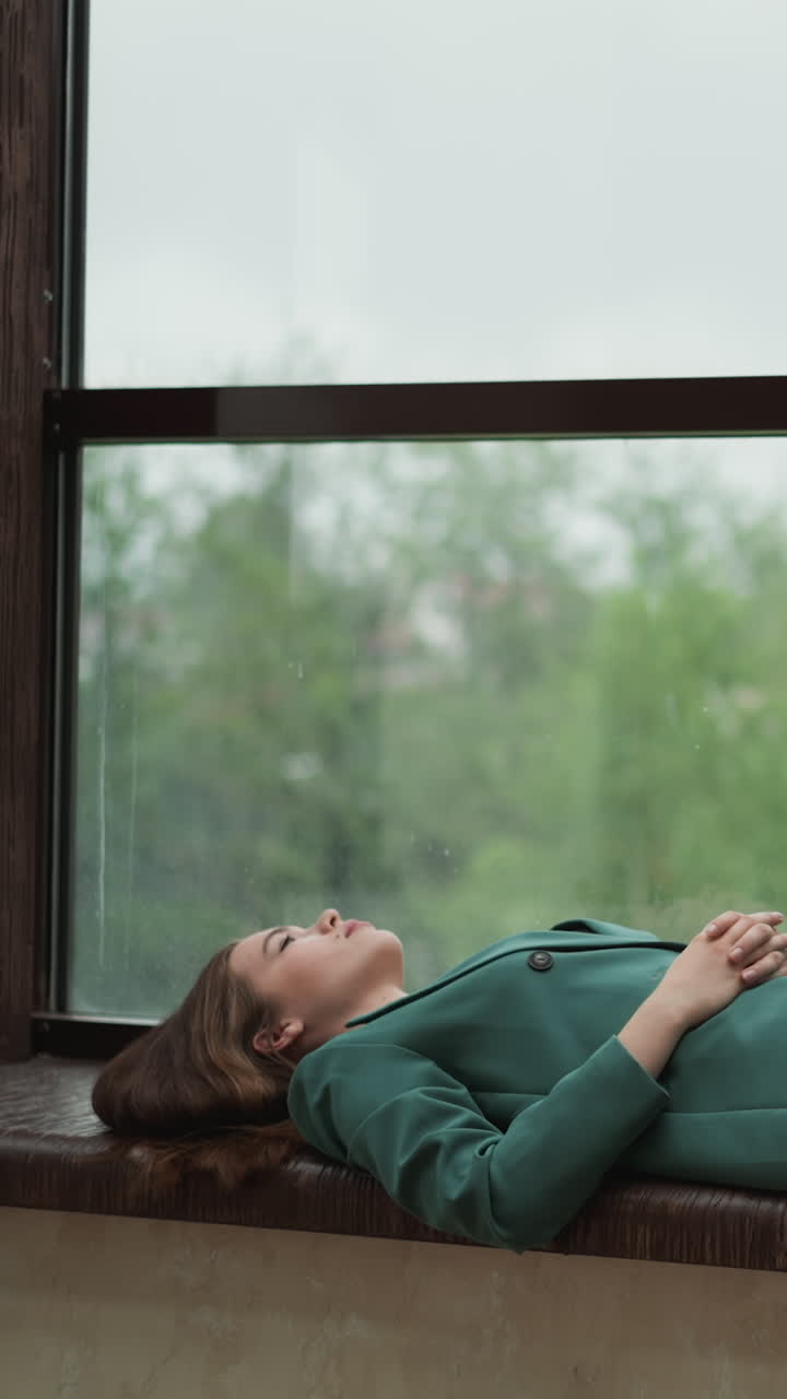 Weary executive collapsed on windowsill. Woman drained from relentless demands of corporate world. Repercussions of relentless overwork in office
