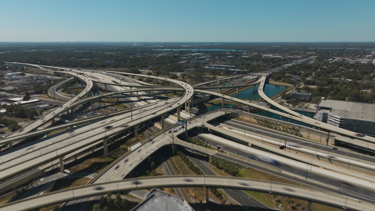 A hyperlapse drone shot showcases Orlando’s major highway interchange connecting the 408 expressway and I-4