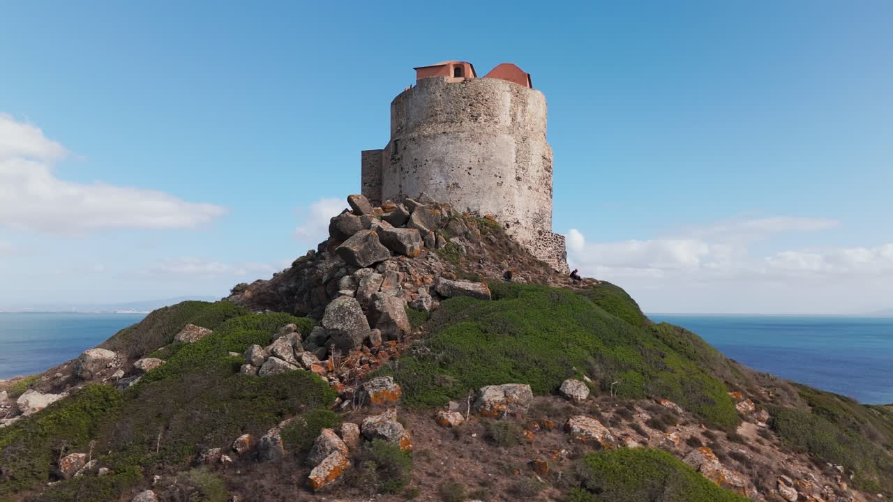 Historic Torre di San Marco stands majestically along the coastline. Surrounded by picturesque views of the sea and lush landscapes, this iconic tower reflects the rich heritage of Sardinia, Italy.