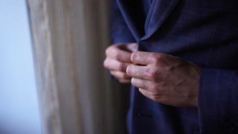 a man buttons up his new jacket