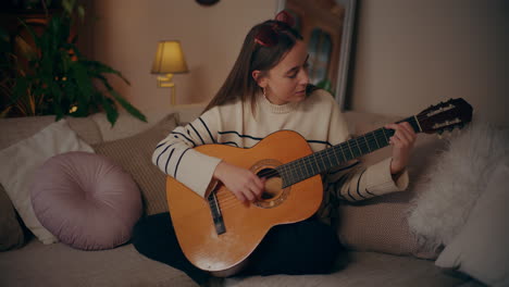 woman playing guitar writing song composing music