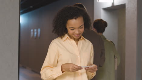 female usher checking movie tickets of a couple at the cinema