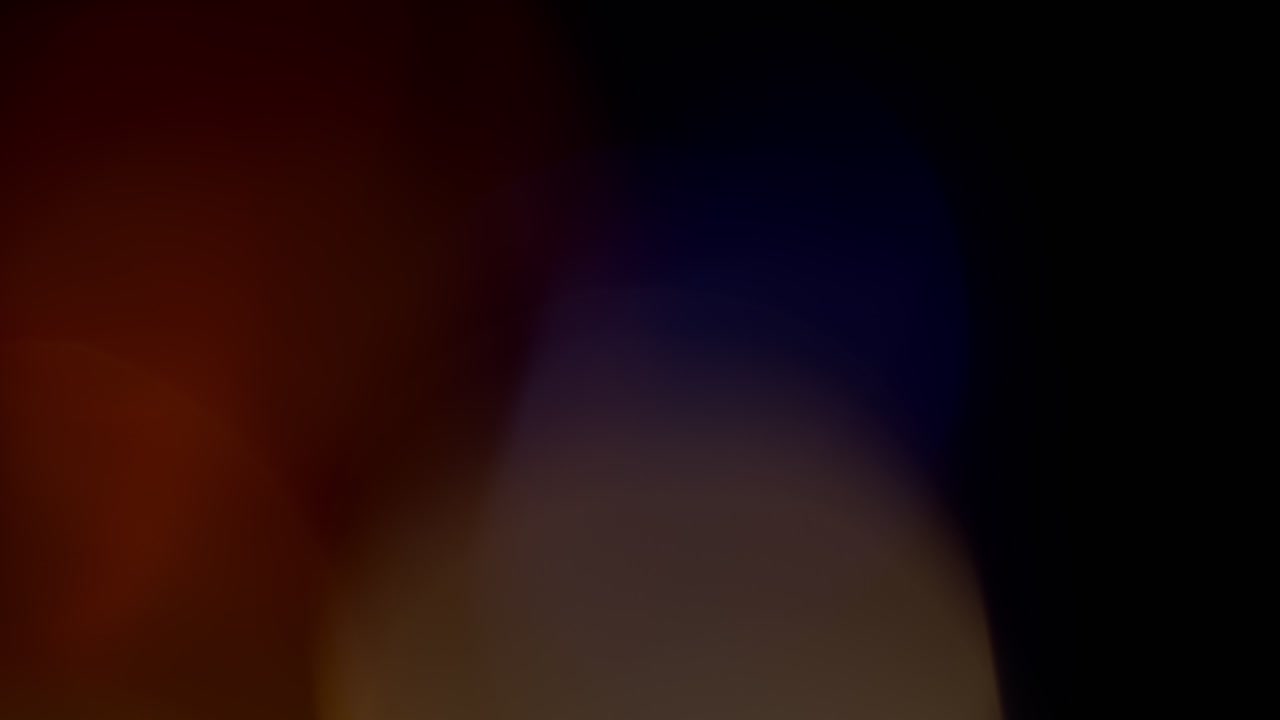 Multicolored light leaks footage on black background, lens flare leak burst overlays transitions