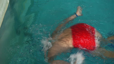 man does a flip turn after swimming using freestyle technique