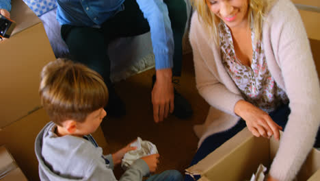 High-angle-view-of-Caucasian-family-packing-their-belongings-in-a-comfortable-home-4k