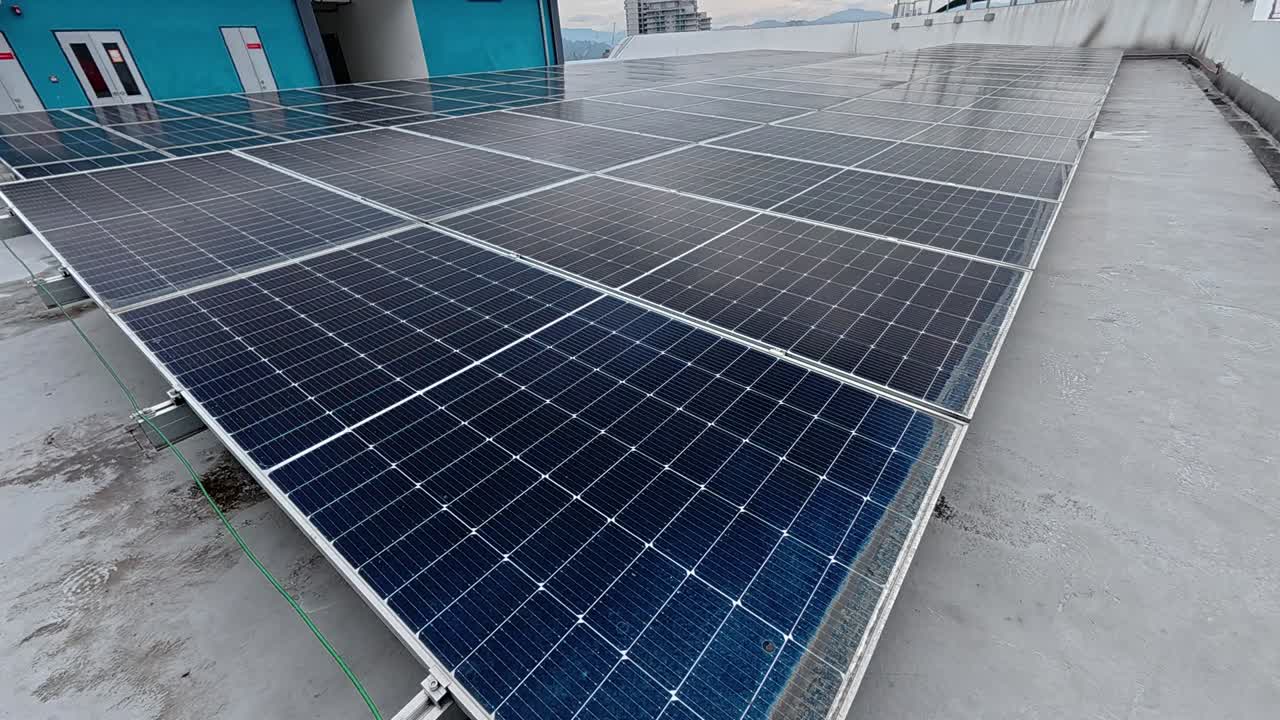 Rows of solar panels installed on a rooftop absorb sunlight, converting it into clean electricity. This sustainable energy source promotes environmental efficiency and supports green living.