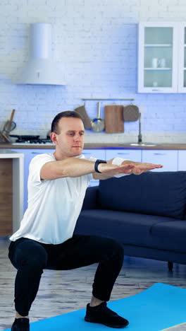sportman doing exercise at home. man doing squats and exercising in living room at home