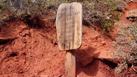 sign asking hikers to stay on the trail to minimize environmental damage to the natural resources