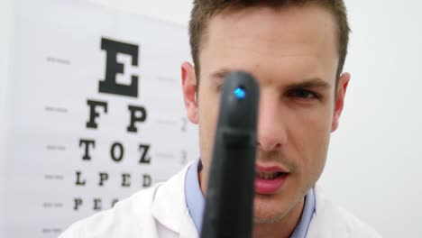 close-up of optometrist looking through ophthalmoscope