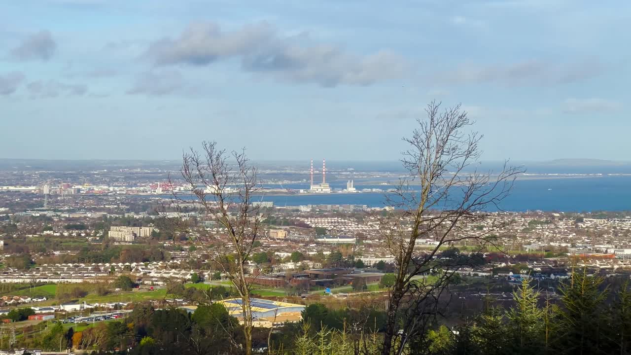 Autumn View Over The Dublin City and Coastline with Poolbeg Towers Framed by Leafless Branches