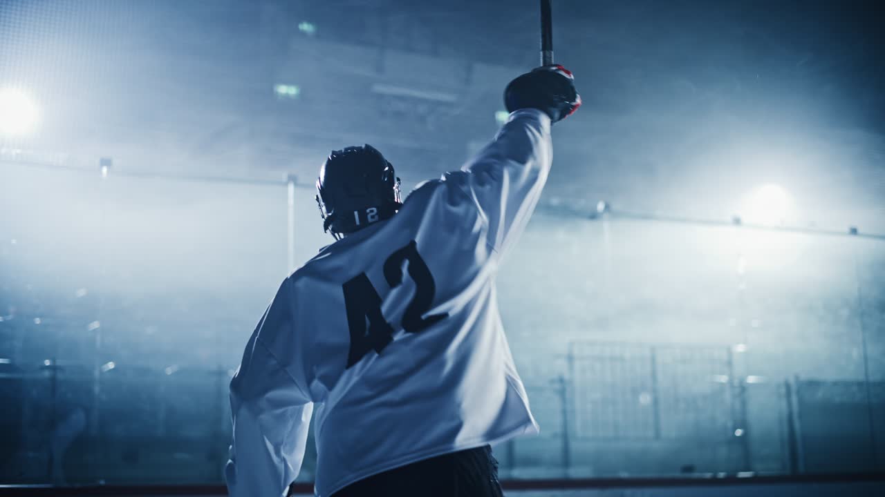 Ice Hockey Game: Professional Player Celebrating Victory on Rink, Raising Arms. Joyful Young Athlete Became a Champion, Through Effort and Determination.