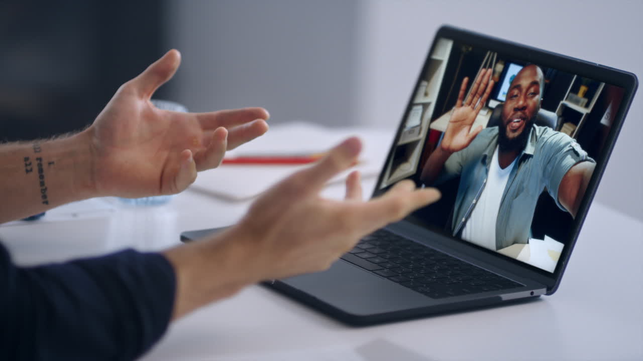 Startupers video calling laptop at office closeup. Freelancer greeting colleague