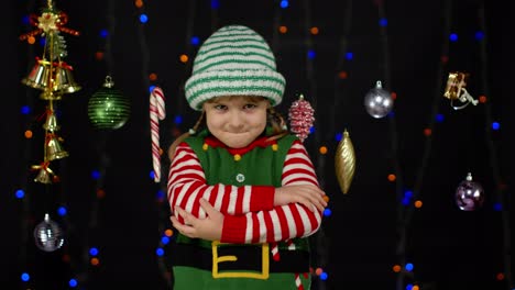 Displesed-kid-teenager-girl-in-elf-Santa-helper-costume-negative-emotions,-upset-on-Christmas-Eve