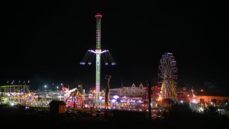 evening view of the amusement park. ferris wheel and other forms of entertainment