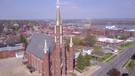 rising aerial shot over small town america church in burlington iowa