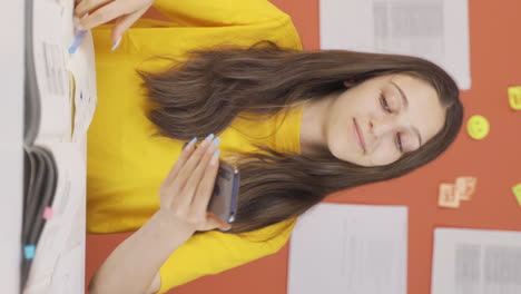 vertical video of phone addicted girl child plays games on the phone at home