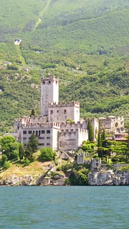establishing view of castello scaligero, from lake garda