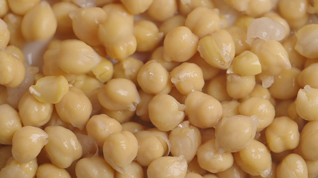 Close-Up of Cooked Chickpeas with Liquid Being Poured