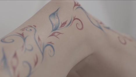 painted floral design on leg