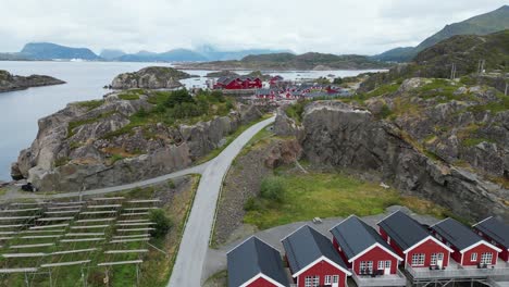 lofoten islands red cabins 'rorbuer' in mortsund fishing village, norway - aerial 4k