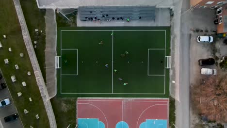 drone flight from bird's eye view over a small soccer field where a game is being played