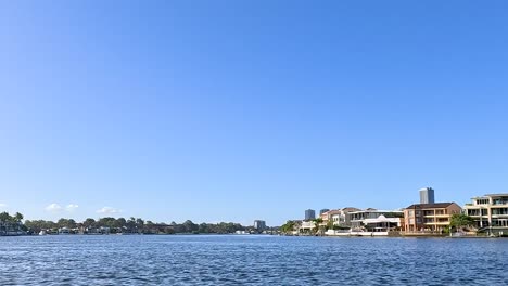 a serene view of waterfront homes against a bright blue sky, capturing the essence of tranquil living.