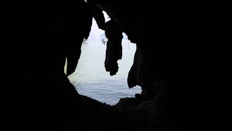 view from inside a cave towards the ocean