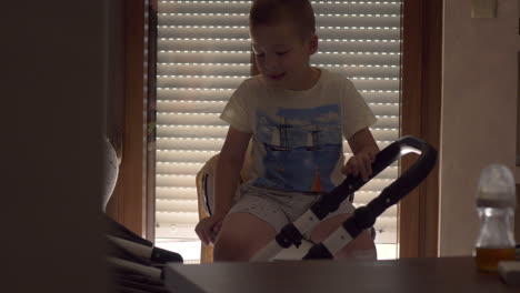 elder brother lulling junior sister to sleep in baby carriage