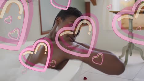 animation of heart icons over african american woman taking bath