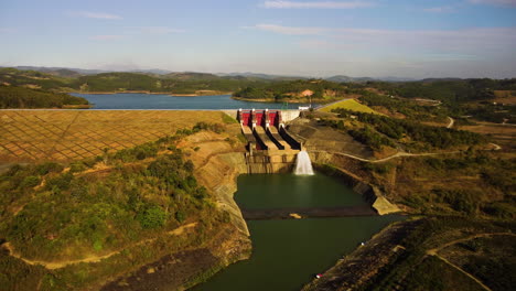 Massive-concrete-dam-near-town-of-Phuoc-Binh-in-Vietnam,-aerial-orbit-view