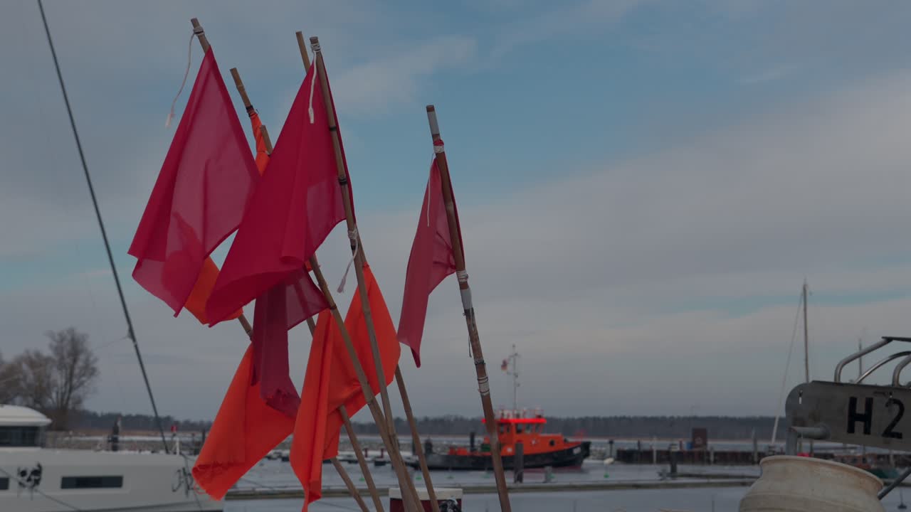 Port close-up of red flags on a fisherman's boat in slow motion