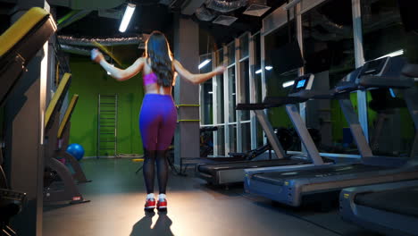 sports women's work using combat ropes. jump rope.