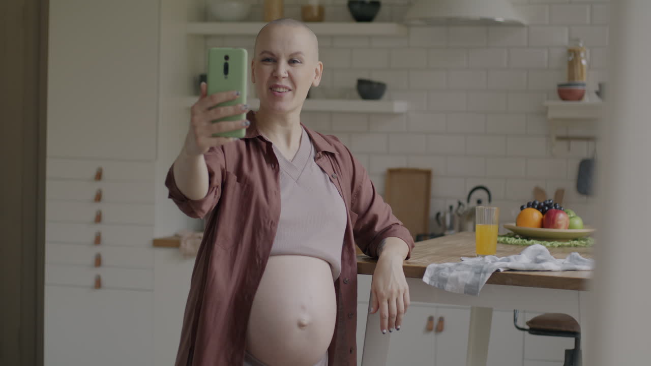 Pregnant Woman Taking Selfie in Kitchen