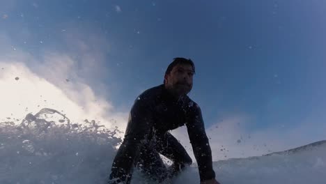 surfer catching a right wave off guincho beach in portugal