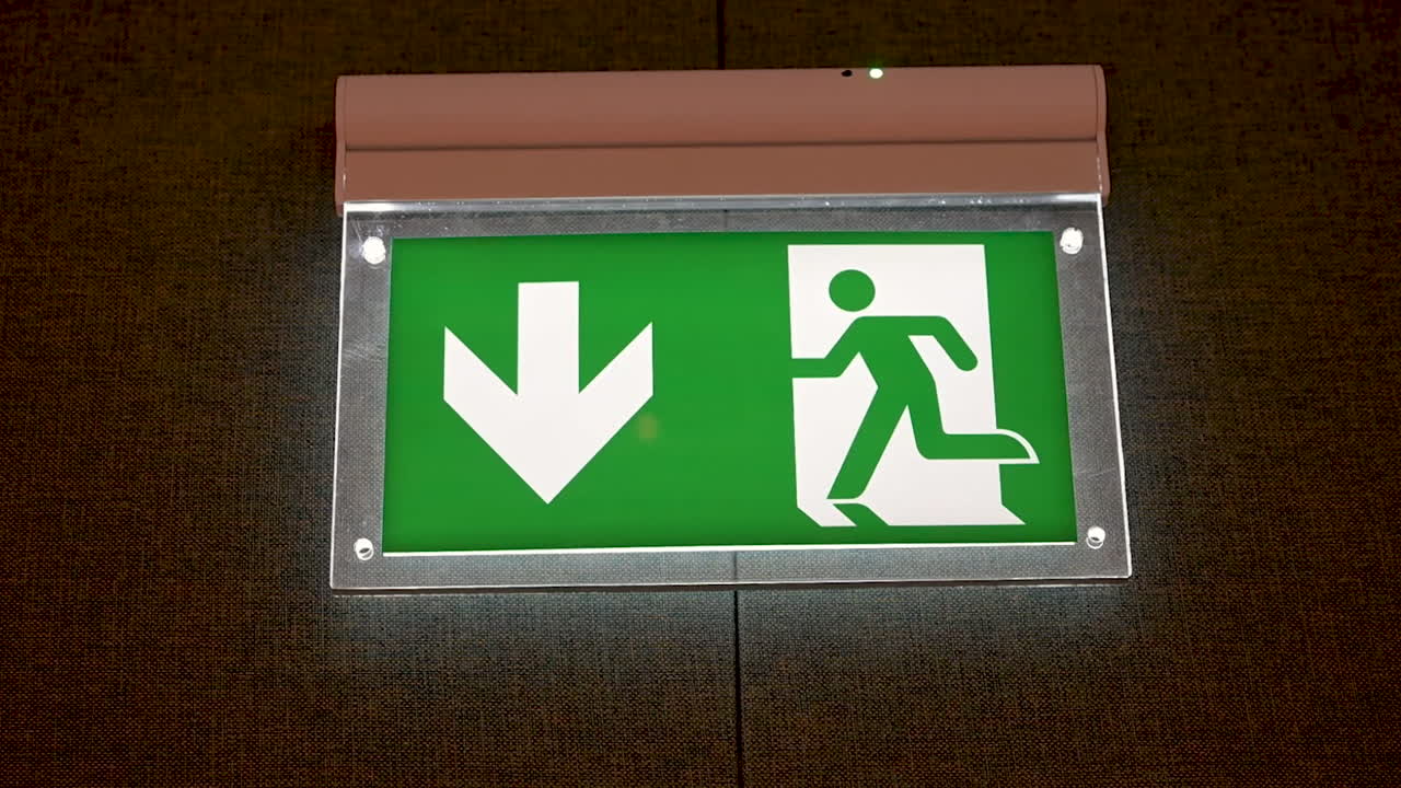 Emergency exit sign in London, United Kingdom, highlighting safety, security, and building infrastructure designed for public protection and quick evacuation