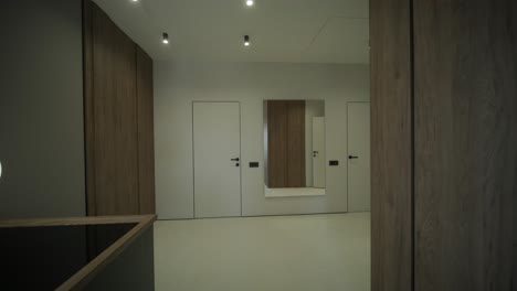 modern hallway with pendant lighting and wood paneling