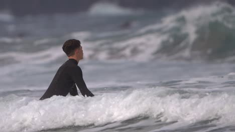 surfer rides a wave in slow motion at gran canaria beach