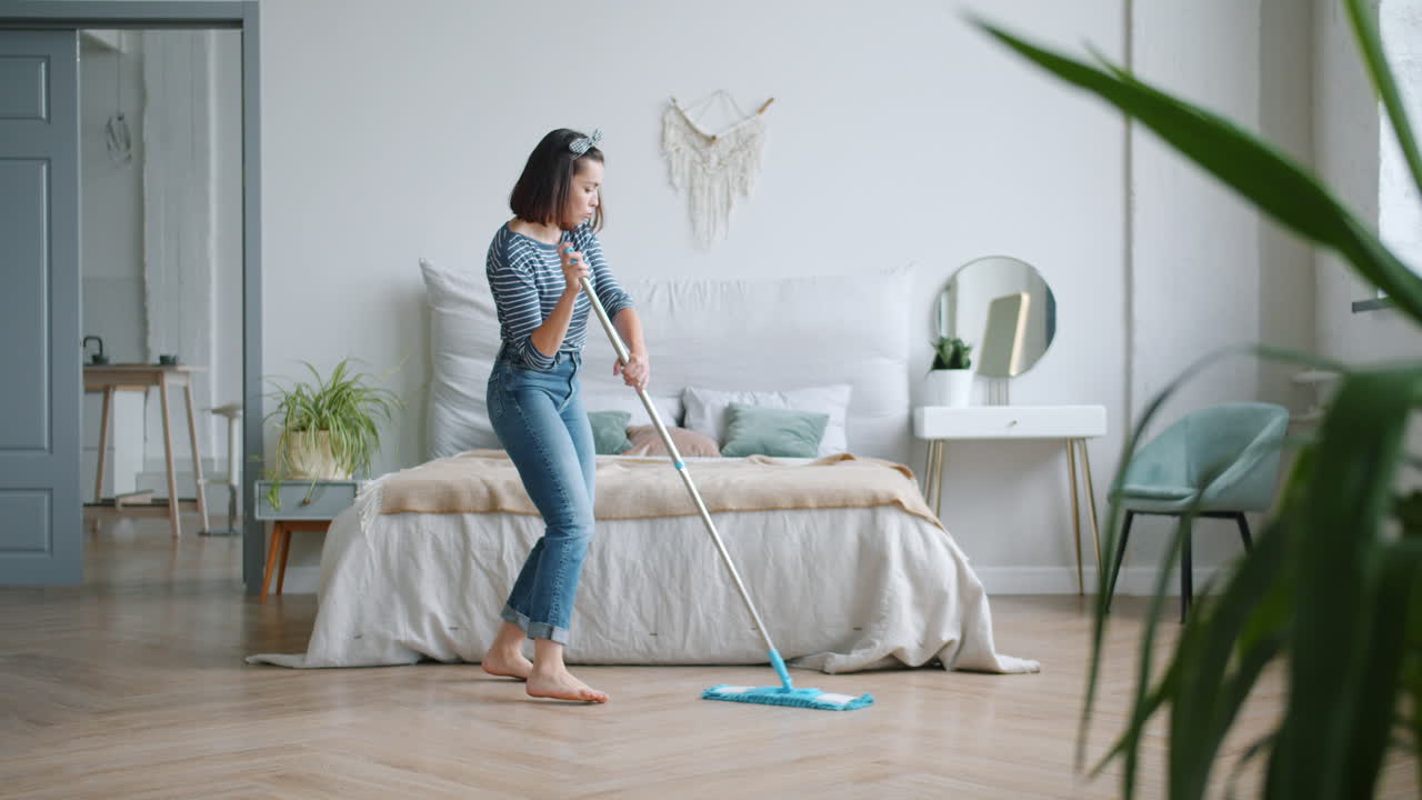 Woman Cleaning Her Bedroom