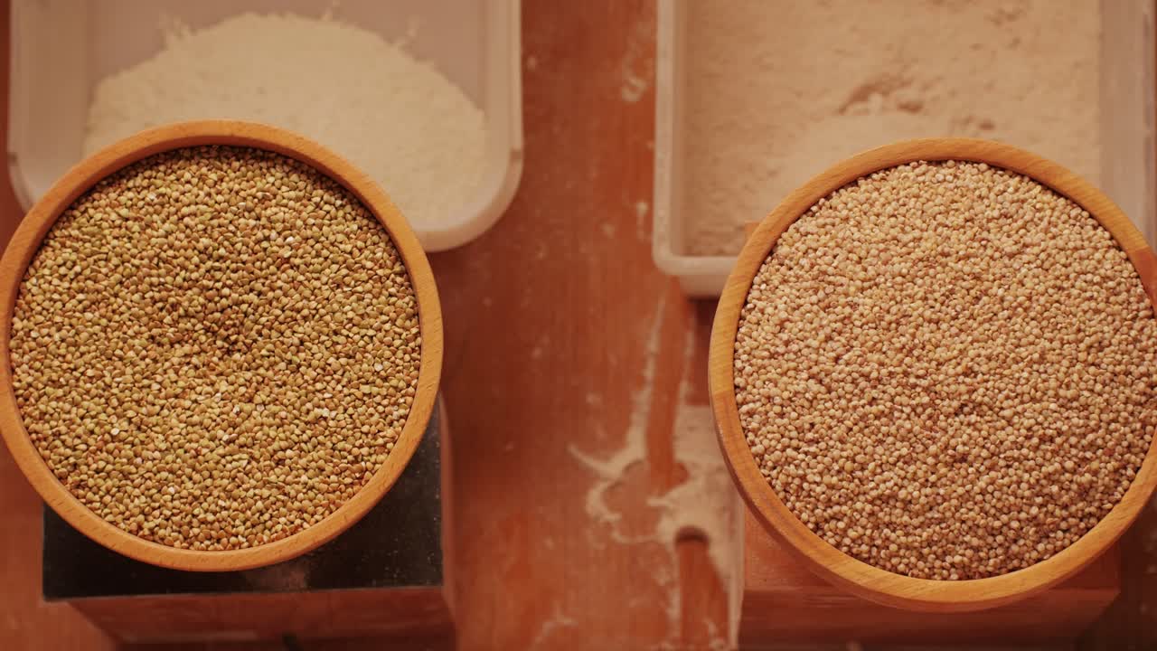 Close-up shot of treatment of seeds of cereals: rye, barley, wheat against diseases and insects using modern equipment. Hard wheat in hopper being ground into whole wheat flour. High quality 4k footage