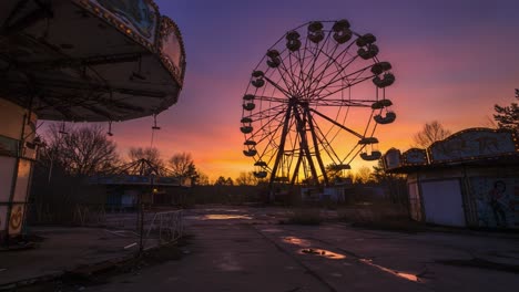 a glimpse of abandonment: sunsetting over a forgotten amusement park featuring an iconic ferris wheel and decaying rides in a state of disrepair